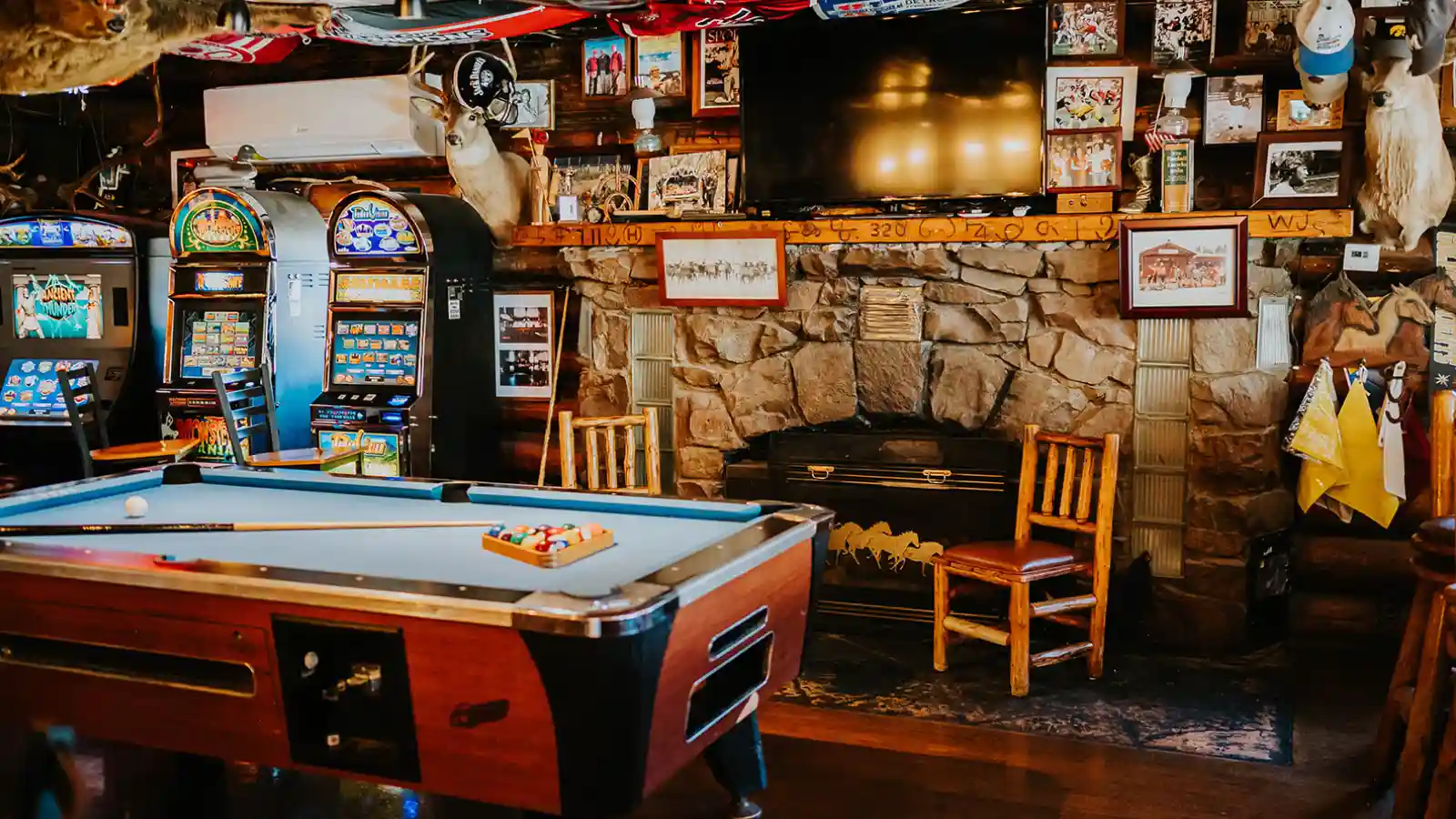 The pool table, fireplace, and gaming machines inside the Corral Bar and Steakhouse in Gallatin Gateway, MT.